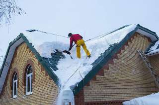 Фото: Промышленный Альпинист чистим снег крыш кровли лед